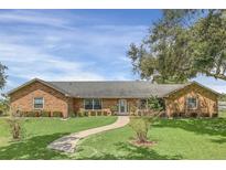 Brick ranch home with a walkway leading to the front entrance at 4147 Boggy Creek Rd, Kissimmee, FL 34744