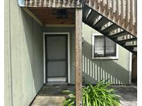 Exterior view of a condo building with stairs and a private entrance at 227 Scottsdale Sq # 227, Winter Park, FL 32792