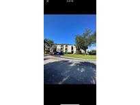 Exterior view of an apartment building with parking at 1916 Lake Atriums Cir # 46, Orlando, FL 32839