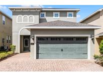 Two-story house with a two-car garage and a landscaped front yard at 280 Pendant Ct, Kissimmee, FL 34747