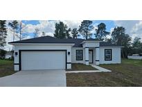 Modern one-story house with attached garage and dark trim at 2648 Sw 146 Th Place Rd, Ocala, FL 34473