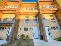 Modern three-story townhome with light-colored exterior and balcony at 3213 Brasilia Ave, Kissimmee, FL 34747