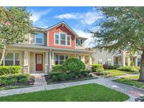 Two-story townhome with red accents and front porch at 2917 Windmill Dr, Kissimmee, FL 34741