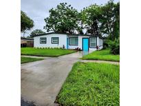 Newly renovated home with a teal door and white exterior at 5819 Colchester Dr, Orlando, FL 32812
