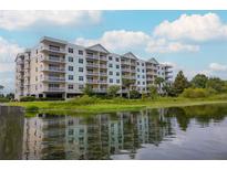Lakeside community featuring a multi-story building with balconies at 4177 N Orange Blossom Trl # 210, Orlando, FL 32804