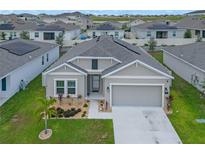 Exterior view of a single-Gathering home with a two-car garage at 757 Citrus Reserve Blvd, Davenport, FL 33837