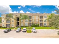 Apartment building with ample parking and landscaped grounds at 2300 Silver Palm Dr # 303, Kissimmee, FL 34747