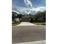 One-story home with two-car garage and mature landscaping at 4738 Blue Diamond St, Kissimmee, FL 34746