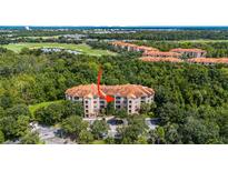 Aerial view of condo building showcasing surrounding landscape at 1301 Tuscan Ter # 9403, Davenport, FL 33896
