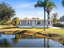 Gray manufactured home with water view at 5303 Holopaw Rd, St Cloud, FL 34773