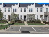 Modern townhouses with stone accents and neatly landscaped yards at 1842 Tropical Palms Cir, Kissimmee, FL 34747