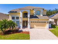 Two-story house with a large driveway and lush landscaping at 1740 N Hampton Dr, Davenport, FL 33897