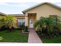 House exterior with a walkway, landscaping, and front entrance at 526 Maricopa Dr, Kissimmee, FL 34758