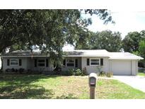Ranch style home with grey siding and a two-car garage at 896 N 9Th St, Eagle Lake, FL 33839