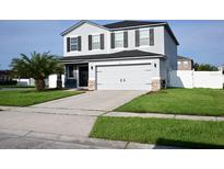 Two-story home with gray siding, black shutters, and a two-car garage at 1816 Stargazer Trl, Kissimmee, FL 34758