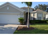 One-story house with two car garage and palm tree at 608 Copeland Dr, Haines City, FL 33844