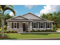 One story house with gray siding, stone accents, and landscaping at 3896 Deer Ridge Dr, Mount Dora, FL 32757