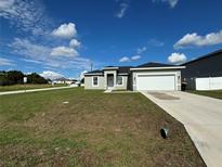 Newly built home with a two-car garage at 129 Lily Ln, Kissimmee, FL 34759