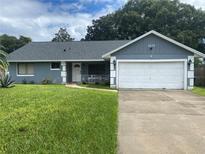 Ranch style home with gray exterior and attached garage at 1615 Martinsville Ct, Orlando, FL 32825