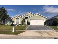 House exterior with a large driveway and well-maintained lawn at 3155 Benson Park Blvd, Orlando, FL 32829