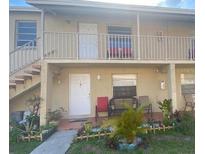 Tan two-story building with stairs and balcony at 725 Michigan Ct # 3, St Cloud, FL 34769