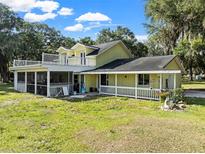 Yellow house with large deck and screened porch at 4350 E Hinson Ave, Haines City, FL 33844