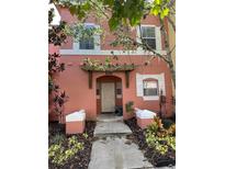 Two-story home with peach-colored exterior and walkway at 4734 Vero Beach Pl, Kissimmee, FL 34746