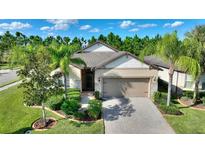 One-story house with a two-car garage and well-maintained landscaping at 341 Navarra Ln, Davenport, FL 33837