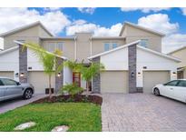 Modern townhome with two-car garage and landscaped front yard at 1157 Challenge Dr # 1157, Davenport, FL 33896