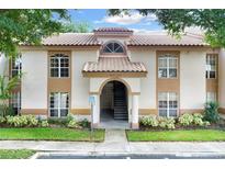 Front view of condo building with stairs and entrance at 4611 Gate Pl # H-203, Orlando, FL 32811