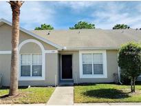 Front view of charming condo with mature landscaping at 2181 Cypress Bay Blvd, Kissimmee, FL 34743