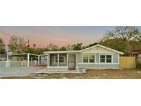 Charming single-Gathering home with a screened porch, carport, and fenced yard at 7980 Alturas Rd, Bartow, FL 33830
