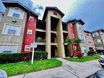Attractive 3-story building with red and gray accents at 2210 Grand Cayman Ct # 1722, Kissimmee, FL 34741