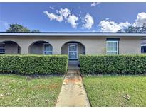 Tan exterior condo building with lush landscaping and walkway at 518 Polaris Loop # 108, Casselberry, FL 32707