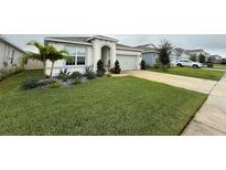 House exterior with well-manicured lawn at 5652 Arborvista Dr, Saint Cloud, FL 34771