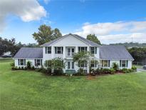 Two story home with white siding and large green lawn at 4155 Quail Wood Dr, Saint Cloud, FL 34772