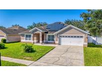 House exterior with solar panels and driveway at 2090 Big Buck Dr, St Cloud, FL 34772