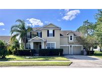 Two story house with a two car garage and manicured lawn at 3040 Palermo Rose Way, Kissimmee, FL 34746