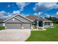 One-story home with two-car garage and landscaped lawn at 3687 Earhart Ave, Lakeland, FL 33810