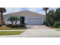 Single-story home with attached garage and landscaping at 12254 Sandy Apple Rd, Orlando, FL 32824