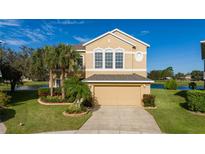 Two-story house with a neutral exterior, landscaped yard, and a two-car garage at 1542 Sun Meadow Dr, Orlando, FL 32824