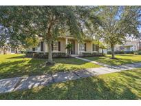One-story home with a landscaped yard and mature trees at 3381 Marshfield Preserve Way, Kissimmee, FL 34746