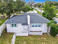Newly renovated house with a gray roof and white exterior at 117 W Maple St, Davenport, FL 33837