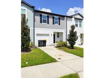 Two story townhome with gray and white siding at 114 Mandovi St, Davenport, FL 33837