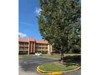 Parking lot with a building in the background at 6402 Parc Corniche Dr # 5208, Orlando, FL 32821