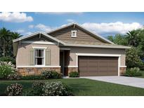 One-story home with brown garage door and landscaping at 2103 Riley Ave, Eagle Lake, FL 33839