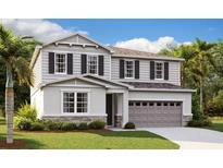 Two-story home with gray siding and stone at 4211 Sawtooth Ct, Tavares, FL 32778