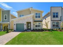 Modern two-story house with a green door and stone accents at 2769 Bookmark Dr, Kissimmee, FL 34746