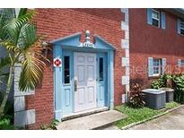 Brick building with light blue entryway and landscaping at 3045 Aaron Burr Ave # 10, Winter Park, FL 32792