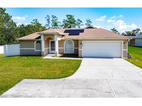 Single-story home with attached garage and solar panels at 119 Talavera Ln, Kissimmee, FL 34758